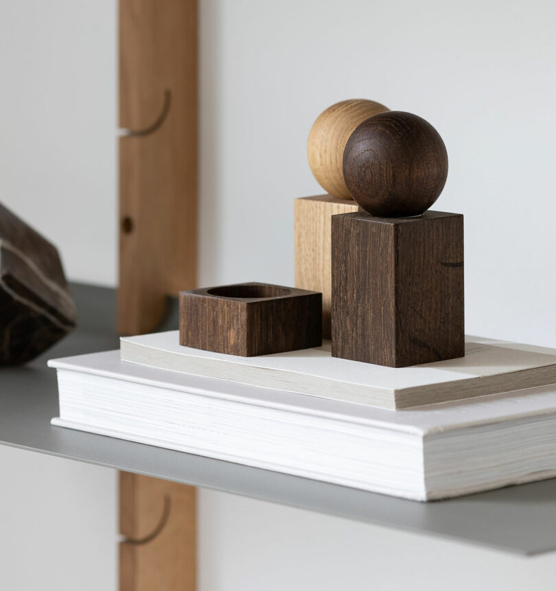 Wooden geometric sculptures arranged on top of a white book