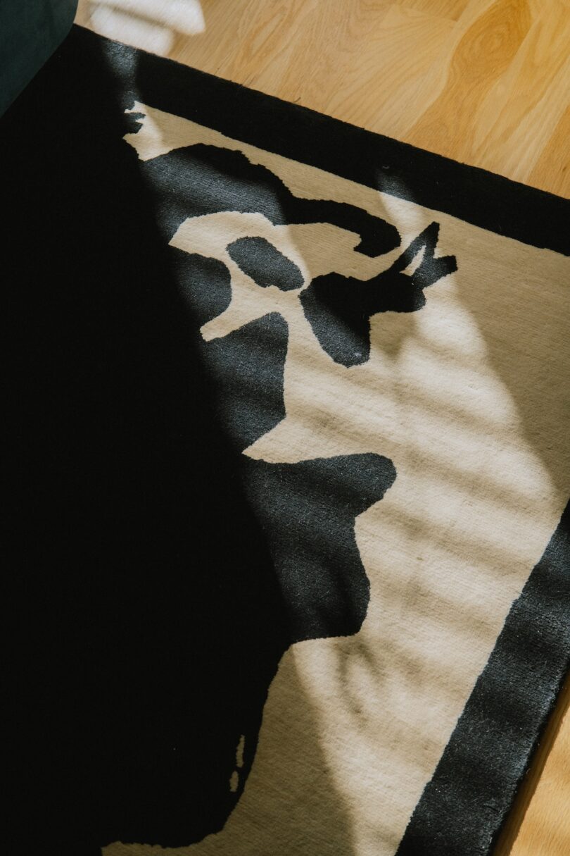 A close-up of a black and beige abstract-patterned rug