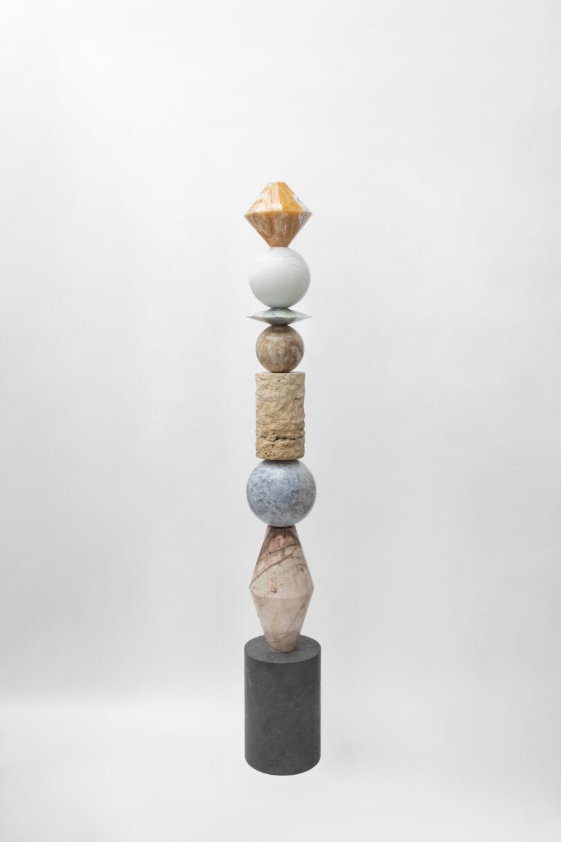 Full view of a sculptural totem from Sten Studio's "Cosmic Relics" collection, featuring multiple geometric shapes made from different types of stone