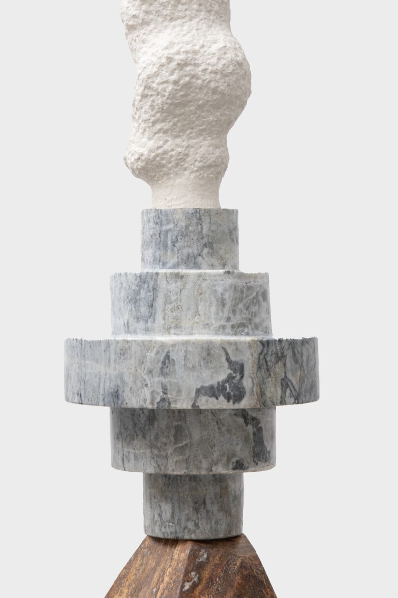 Detailed view of a stacked sculpture from Sten Studio's "Cosmic Relics" collection, featuring layered stone elements with distinct textures and colors