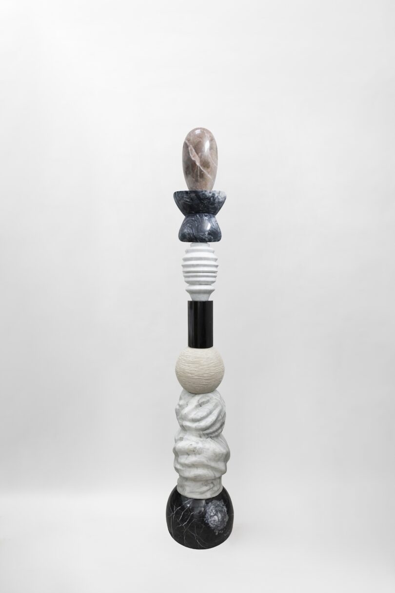 Full view of a sculptural piece from Sten Studio's "Cosmic Relics" collection, showcasing a combination of black, white, and grey stone elements