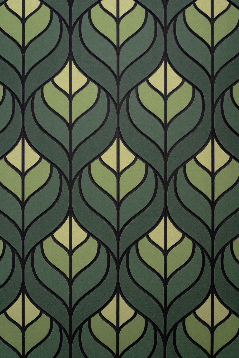 A green and beige wallpaper features a repeating leaf pattern outlined in black