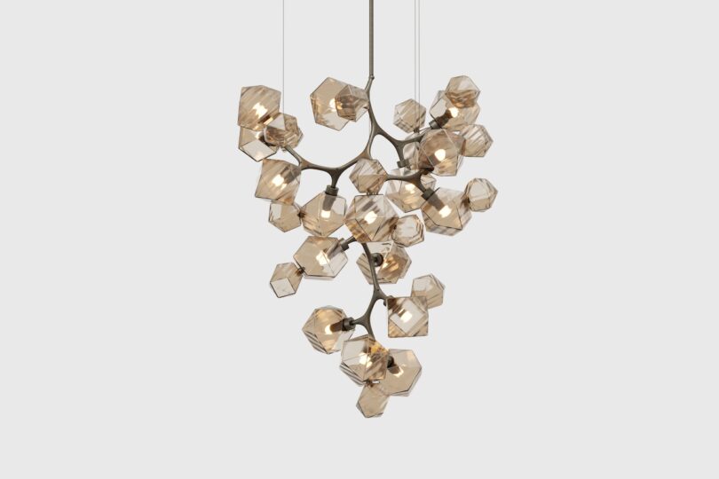 Modern chandelier with multiple geometric-shaped glass fixtures arranged on a branched metal frame