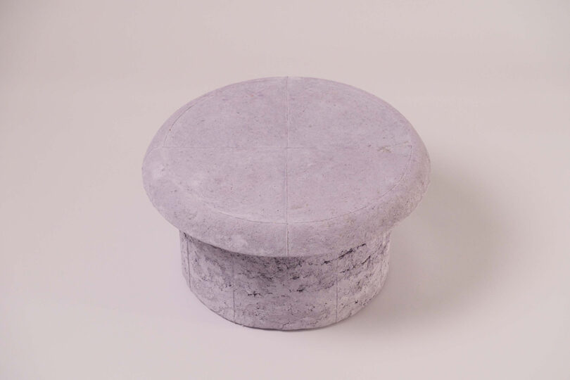 A stool from the Pastille Collection by Emeline Ong with a flat top and cylindrical base.