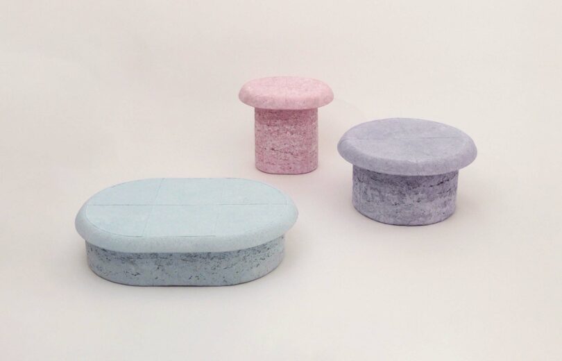 The full Pastille Collection on view: a lower pink table in the back and two blue tables in the front, set against a plain, light-colored background.