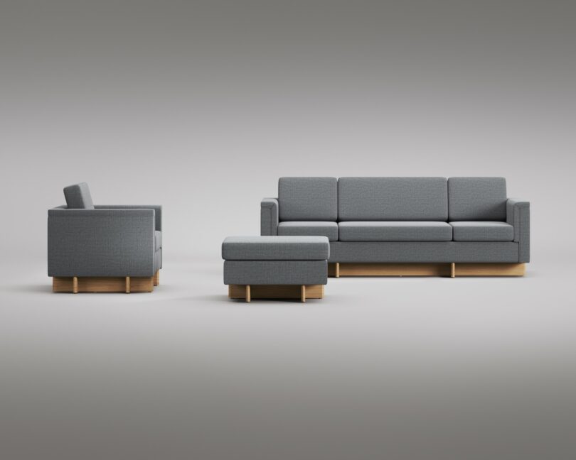 A grey upholstered sofa set with wooden bases, featuring a three-seater couch, a single armchair, and an ottoman, arranged on a plain background. The clean lines and functional design echo the timeless style of Frank Lloyd Wright.