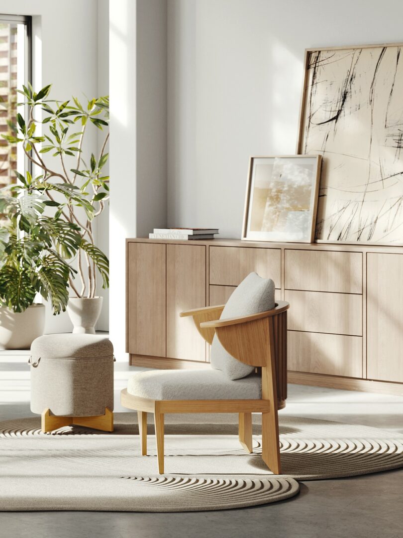 A minimalist room with a light wooden chair and ottoman, an abstract painting on a sideboard, potted plants, and large windows letting in natural light—reminiscent of Frank Lloyd Wright's harmonious design principles.