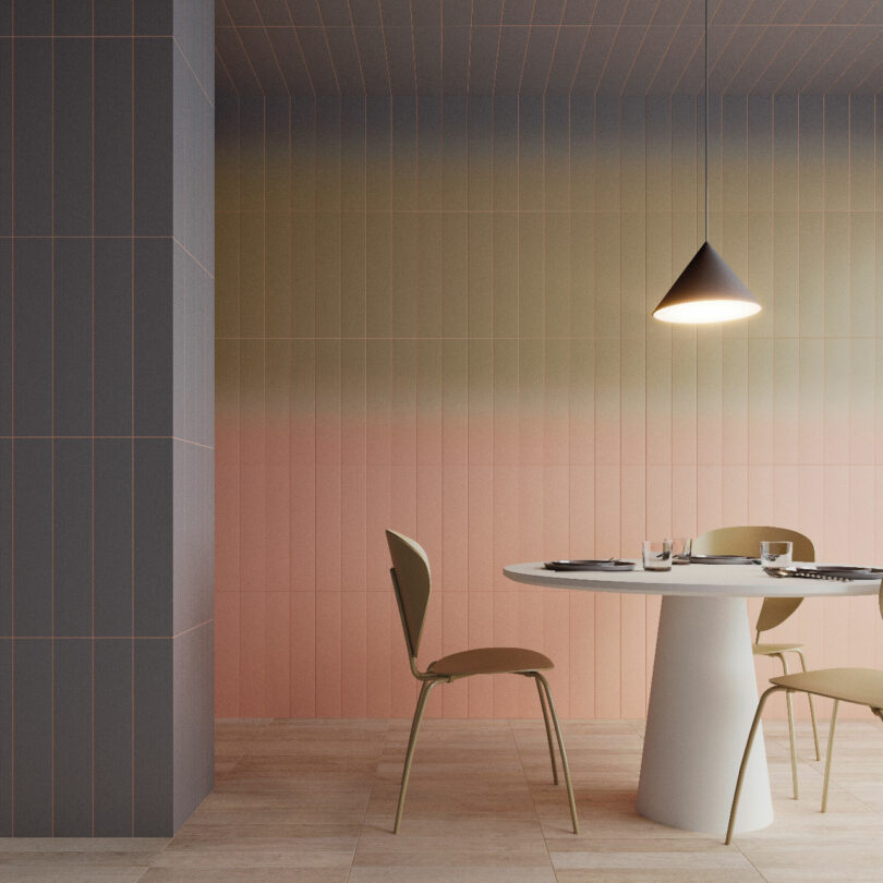 A modern dining area with two chairs and a round table set for two. The walls have a gradient color and a cone-shaped pendant light hangs above the table. The floor has light wood planks.