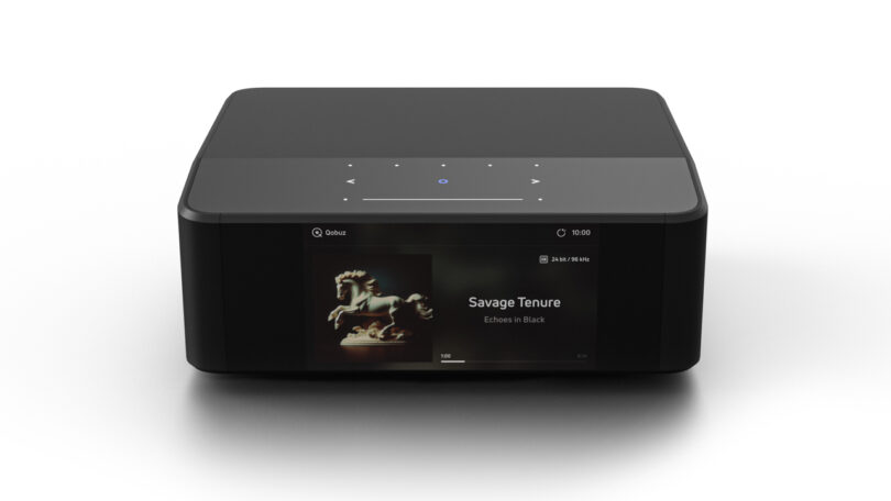 A black rectangular music streaming device with a touch interface and display screen showing "Savage Tenure" by Echoes in Black.