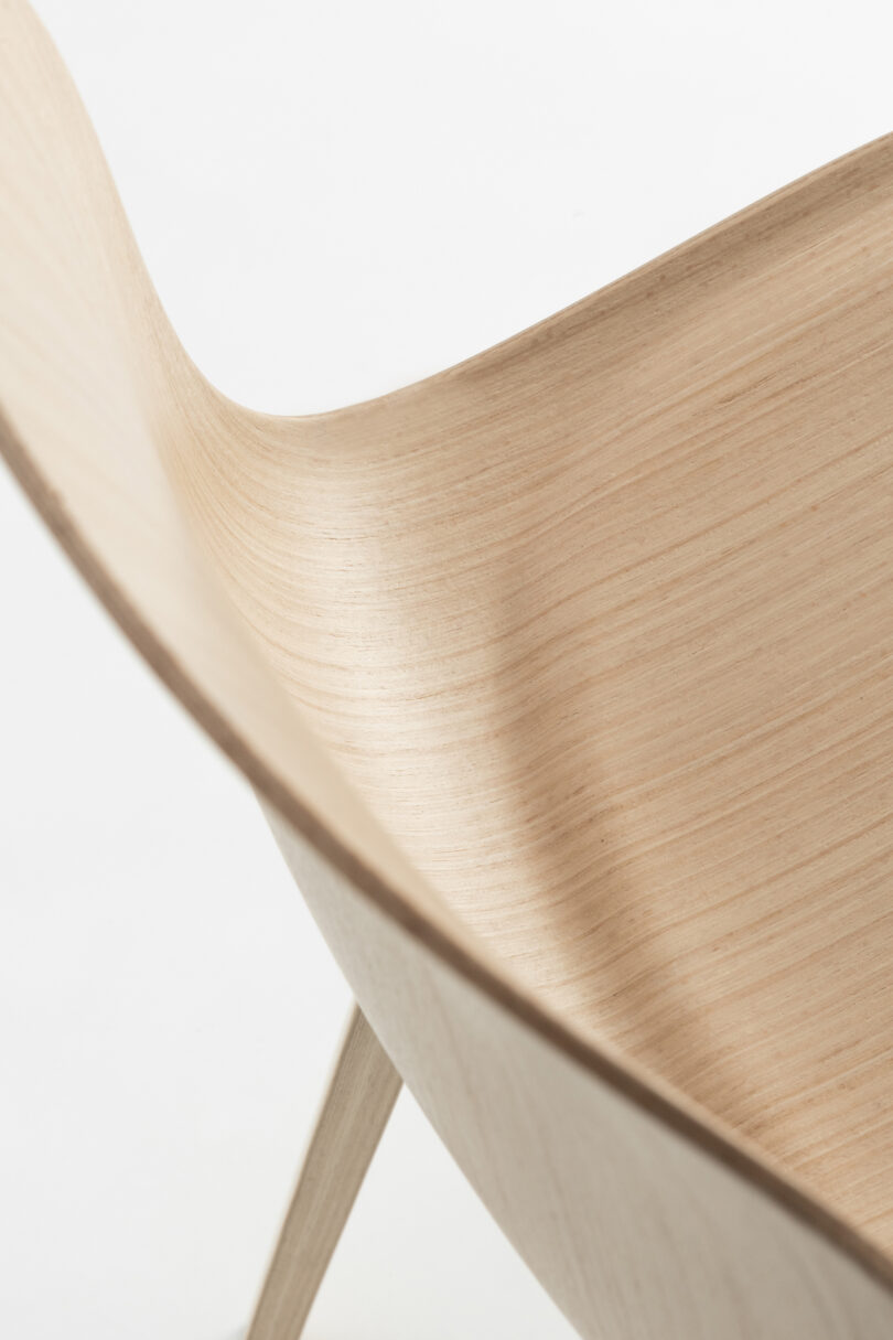 upclose details of A light wood, curved-back chair 