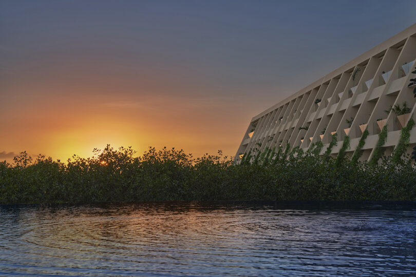 A sunset view of The Riviera Maya EDITION, with its modern architecture rising from the surrounding mangroves