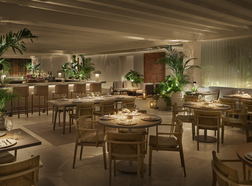 A warmly lit dining area at the KI’IS restaurant in The Riviera Maya EDITION