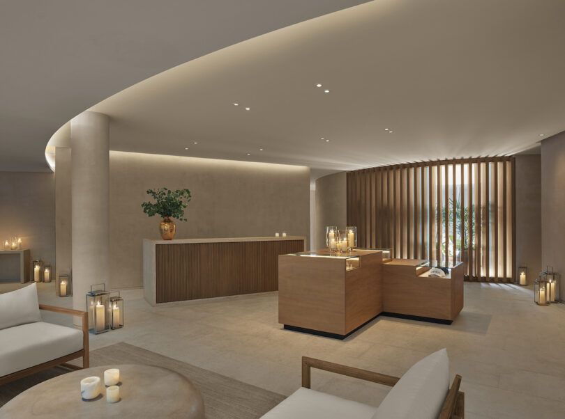 A reception area for The Spa at The Riviera Maya EDITION with minimalist design, soft lighting, and wooden accents