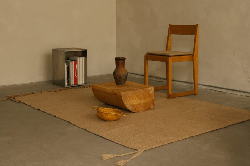 A minimalist setting with a Beni rug, simple wooden furniture