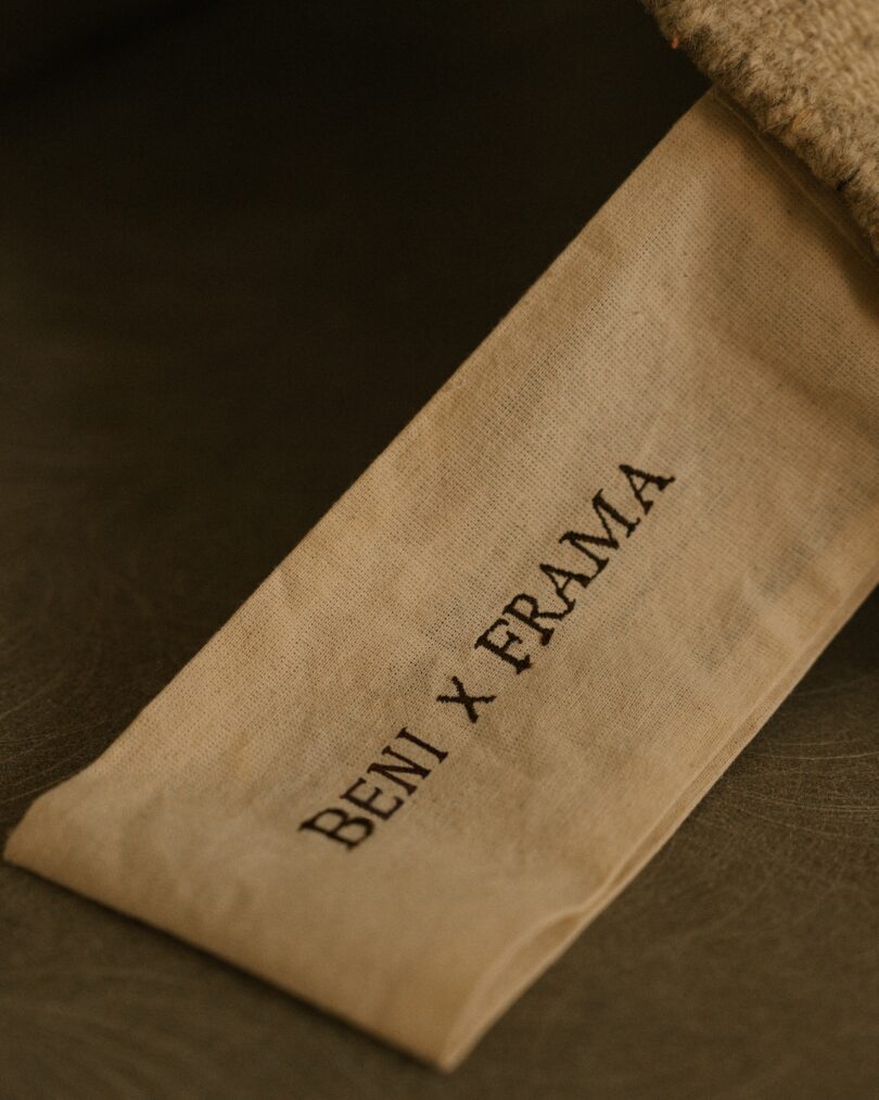 A close-up of a Beni x Frama label attached to a rug