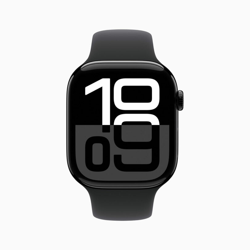 An Apple Watch with a black band displays the time 10:09 on a dark, minimalist digital face.