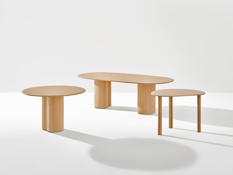 Three Ghia Tables of varying shapes and sizes are placed against a plain white background. The tables have simple, minimalist designs with cylindrical and rectangular legs.