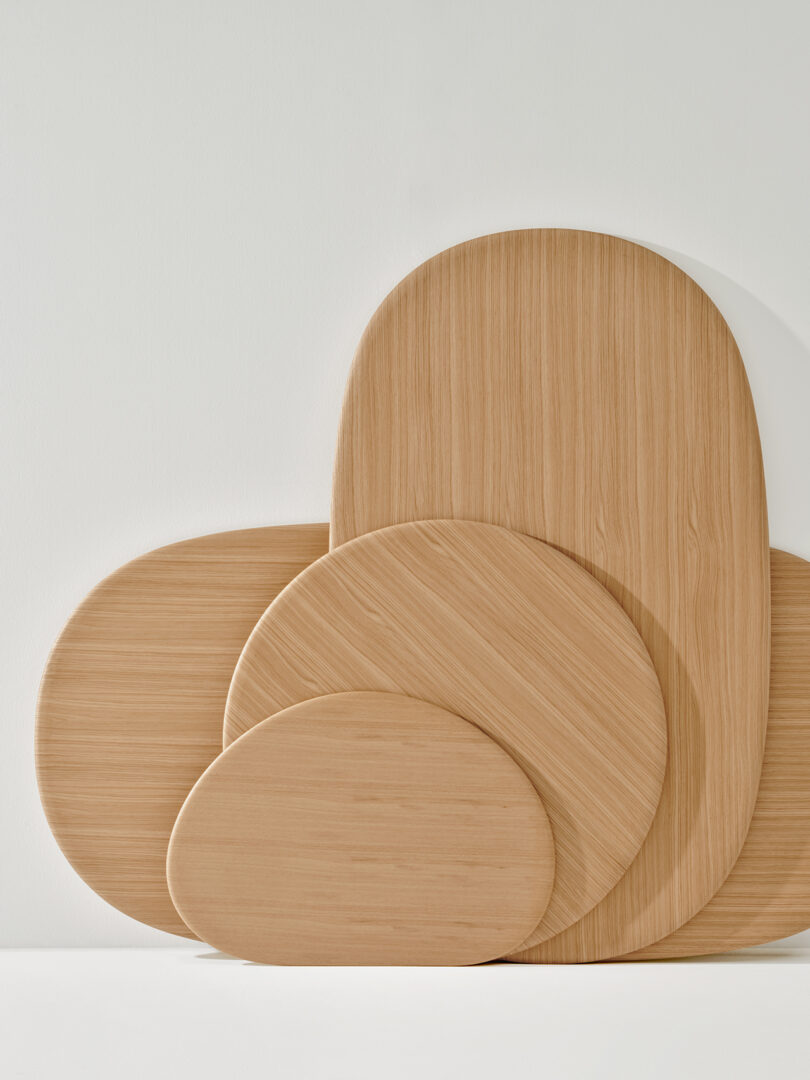 A set of five overlapping, smooth, wooden Ghia tabletops of various sizes and shapes against a plain white background.