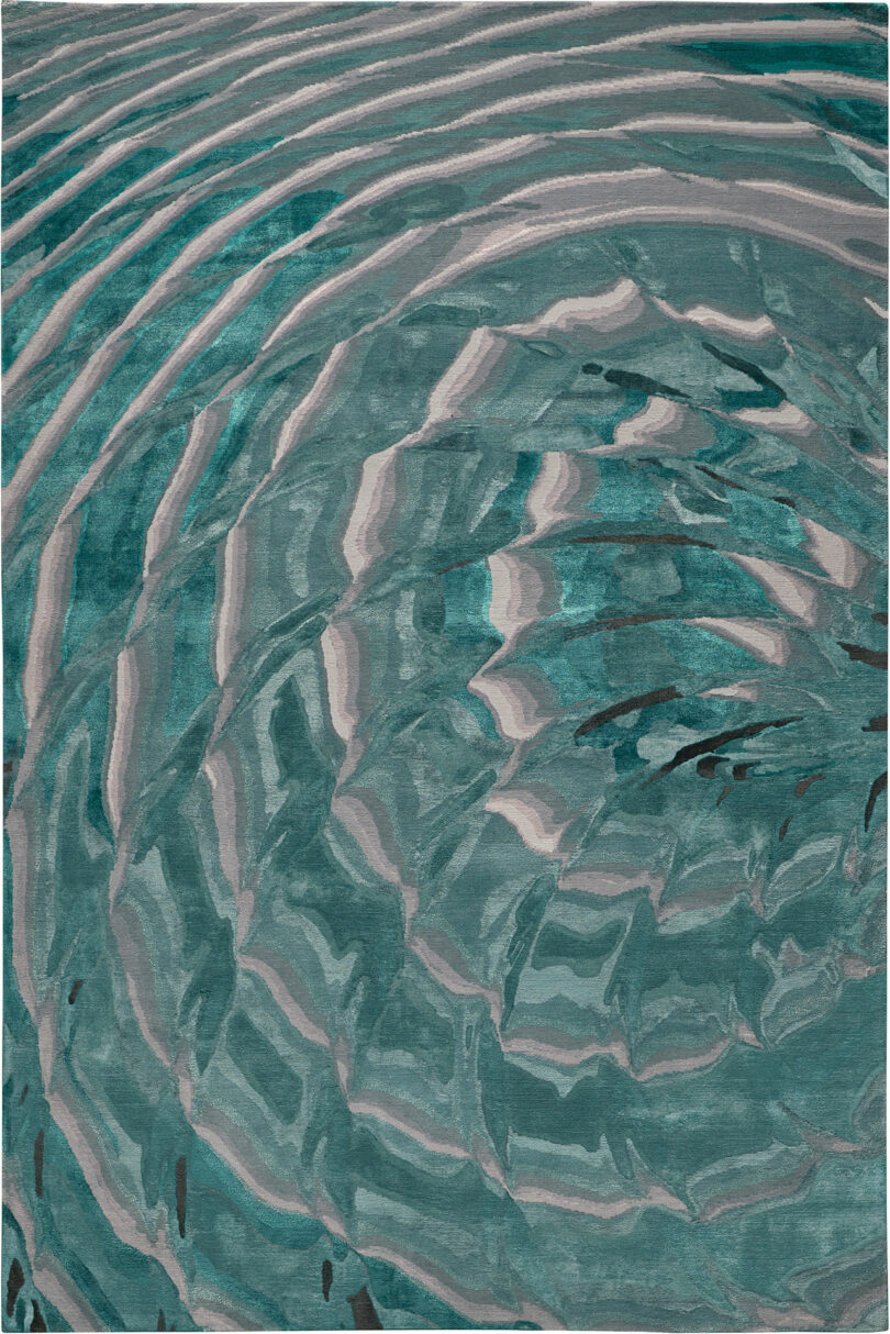 Abstract depiction of concentric ripples in varying shades of teal and gray. The pattern resembles water waves, creating a dynamic and textured appearance reminiscent of Dale Chihuly's glass sculptures.