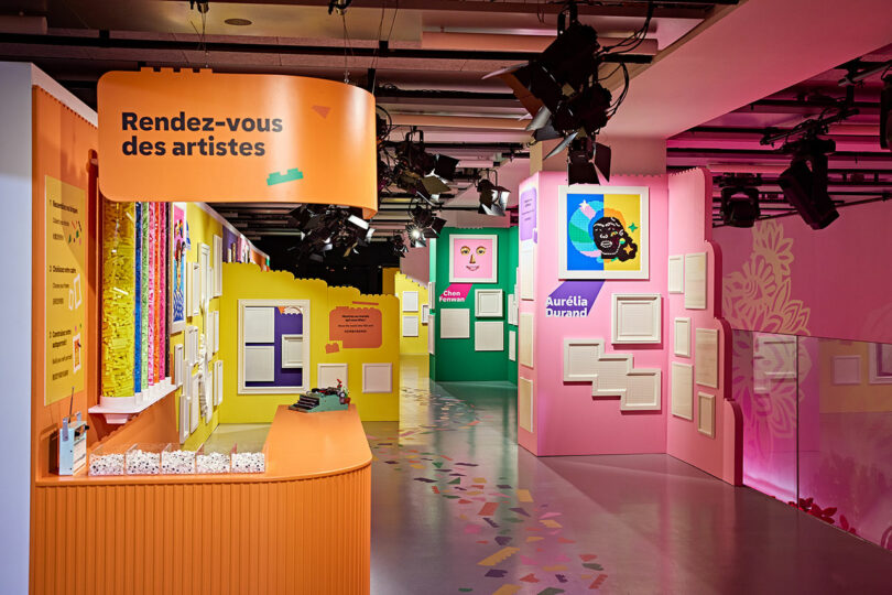 Colorful indoor space with brightly painted walls and art displays. The entrance labeled "Rendez-vous des artistes" in French. Various artworks and frames are mounted on the walls.