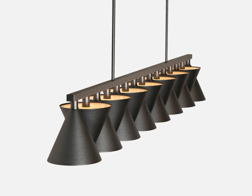 A Legato Linear Light - a row of black lamps.