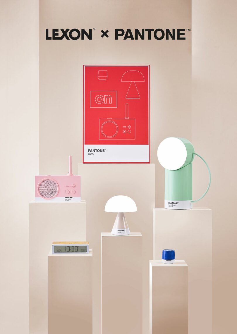 Display of Lexon and Pantone collaborative products including lamps, radios, and clocks, set against a minimalist beige backdrop with a central red poster featuring the brands' logos.