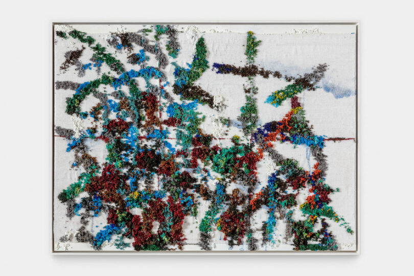 Abstract painting in green, blue and red made from beads.