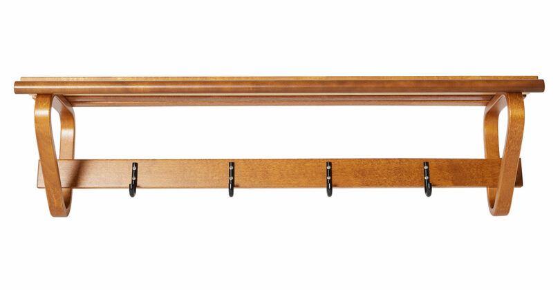 Coat Rack 109 by Alvar Aalto with a shelf on top and five black metal hooks underneath.