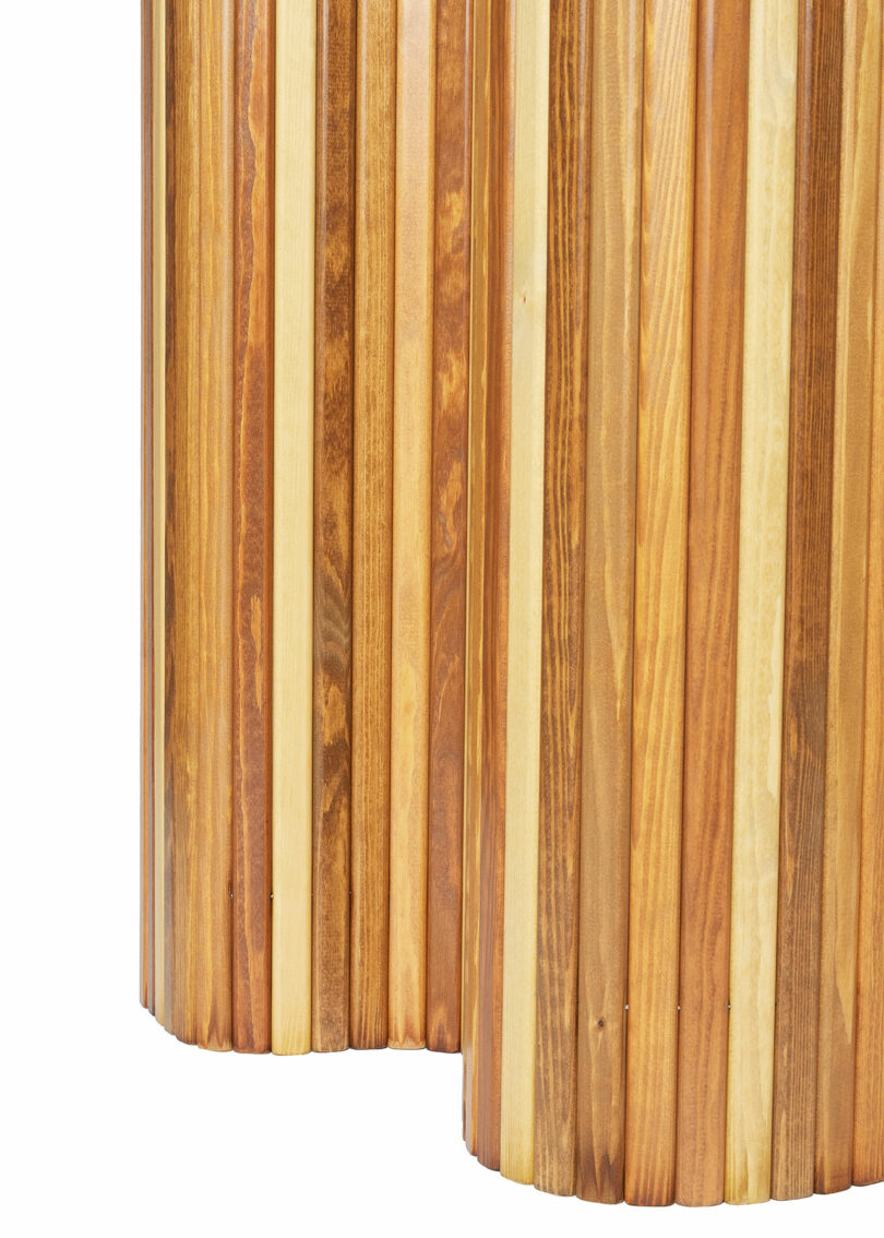 Close-up of Screen 100 by Alvar Aalto, a vertical wooden slat panel with alternating light and dark wood tones, showing the natural grain and texture.