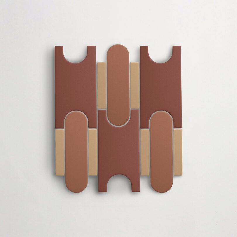 A Tivoli Tech tile geometric shapes in brown, beige, and tan hues, arranged in a symmetrical pattern on a white background.