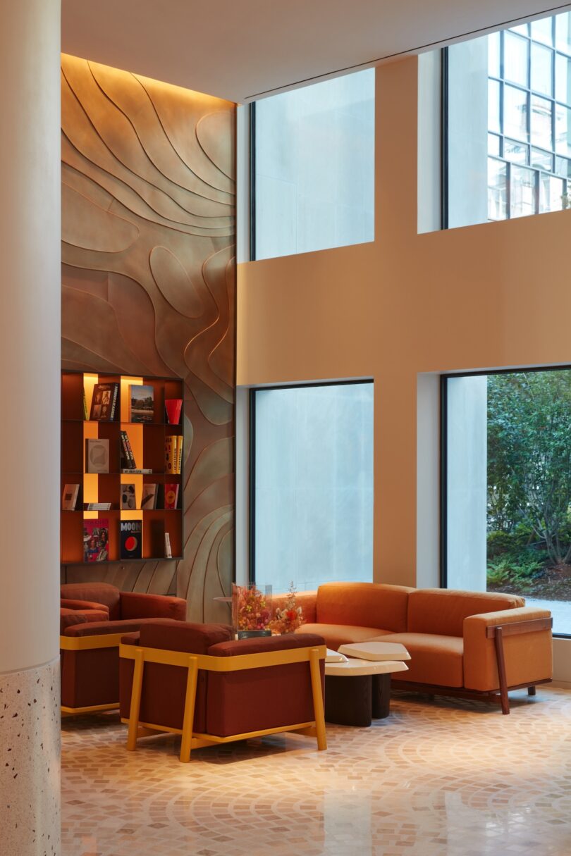 A cozy seating area in the SO/Paris lobby, designed with warm, inviting tones and custom furniture