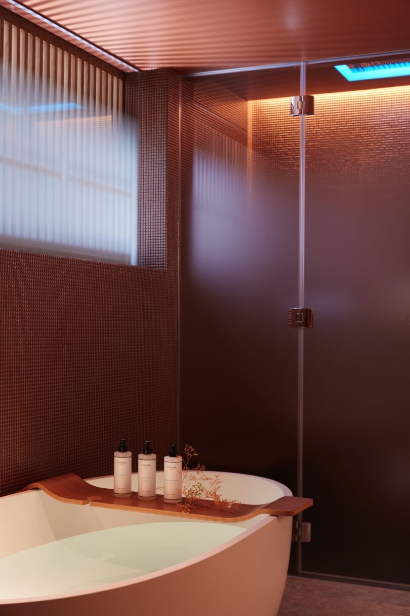 A chic, minimalistic bathroom at SO/Paris with a soaking tub and high-end Codage bath products