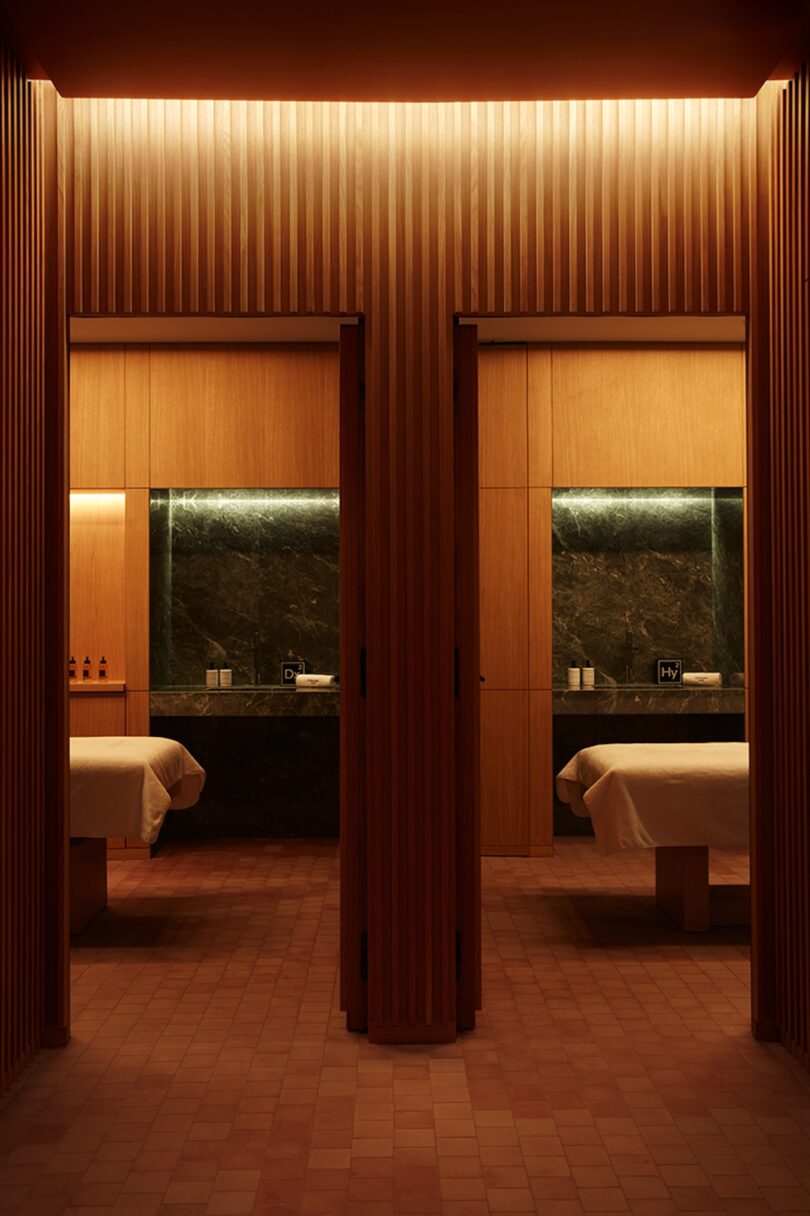 A serene and elegantly lit spa treatment room at SO/Paris, featuring wood paneling and minimalist design 