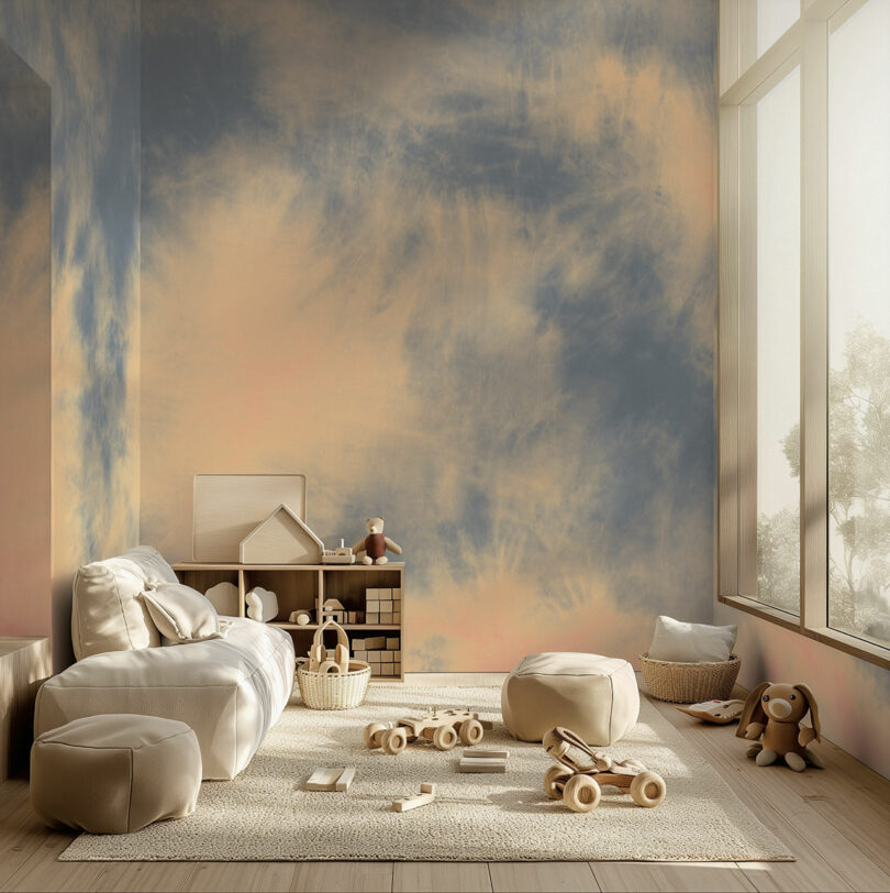 A serene playroom with large windows, decorated with a cloudy sky mural. It features plush seating, a wooden shelf with toys, stuffed animals, and a light rug with scattered toy cars and blocks.