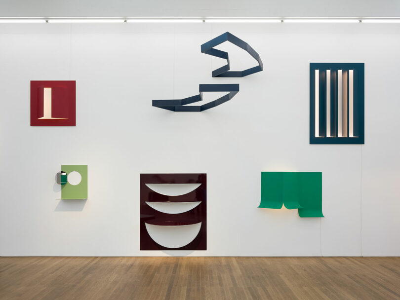 Art installation with geometric shapes mounted on a white wall