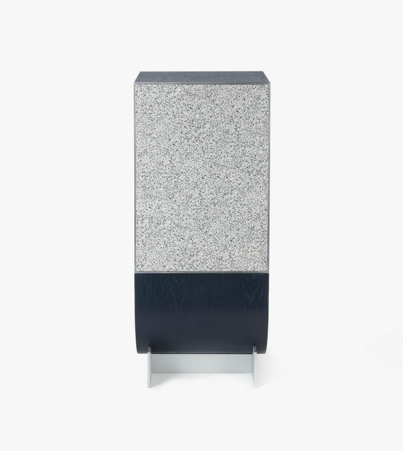 A rectangular, freestanding trash can with a gray speckled design on the top half and a solid black base.