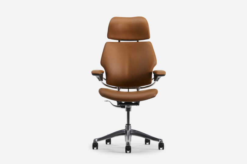 Office chair with brown upholstery, ergonomic design, adjustable armrests, and a headrest on a five-wheel base