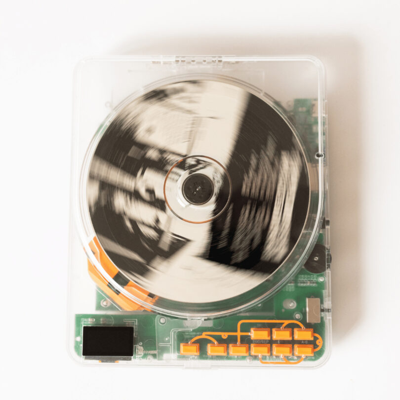 A transparent device with visible internal components, including a spinning disc in the center.