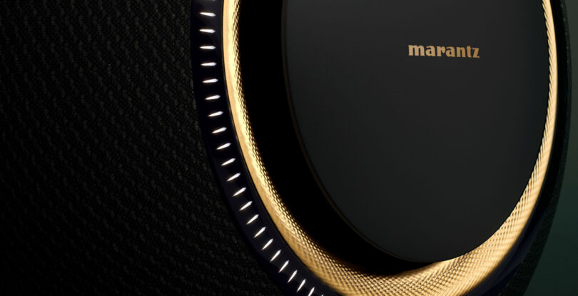 Close-up of a Marantz audio speaker with circular LED lighting and a textured surface.