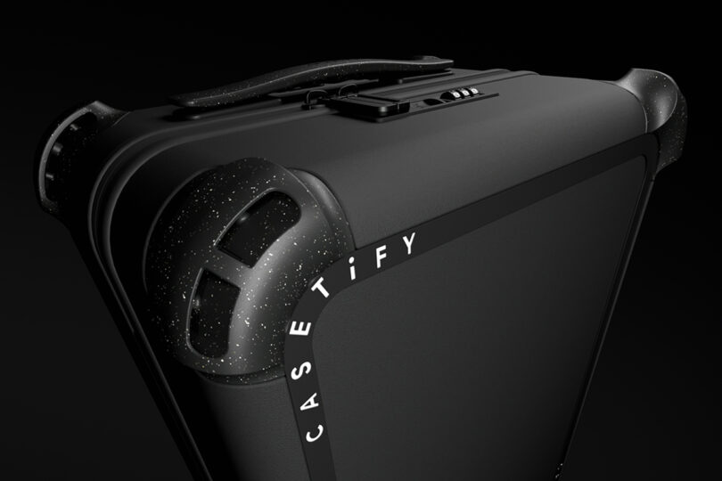 A sleek, black suitcase with rounded corners and a handle on top, featuring CASETIFY branding in white letters.