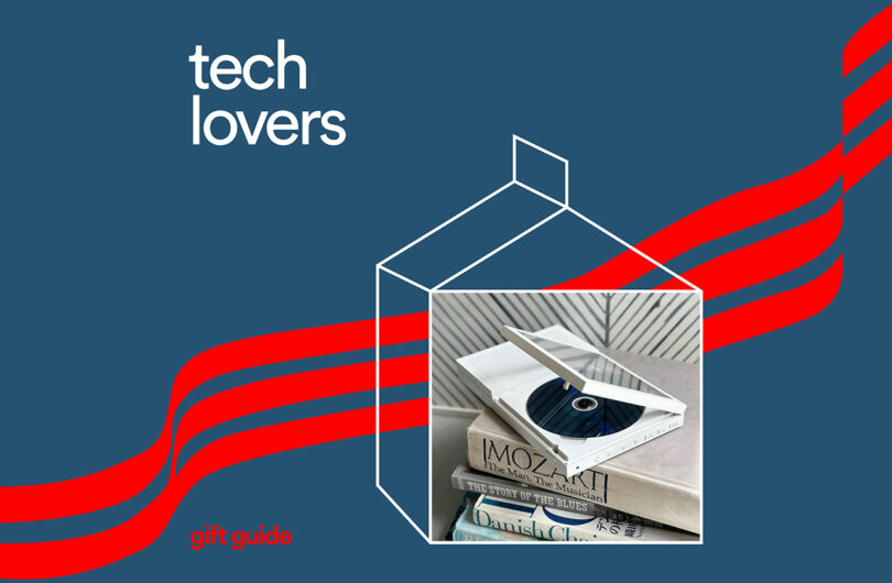 A CD player rests on stacked books, perfect for tech lovers diving into gift guides, with "Tech Lovers" text on a blue background and red stripes.