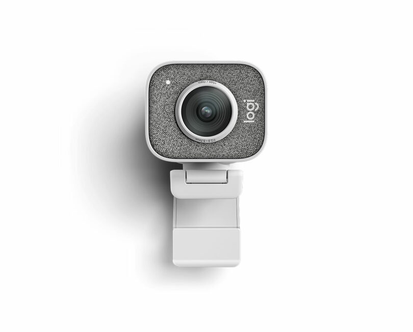 A square-shaped webcam with a textured front, reminiscent of Giulio Barresi's sleek designs, mounted on a white clip against a pristine white background.