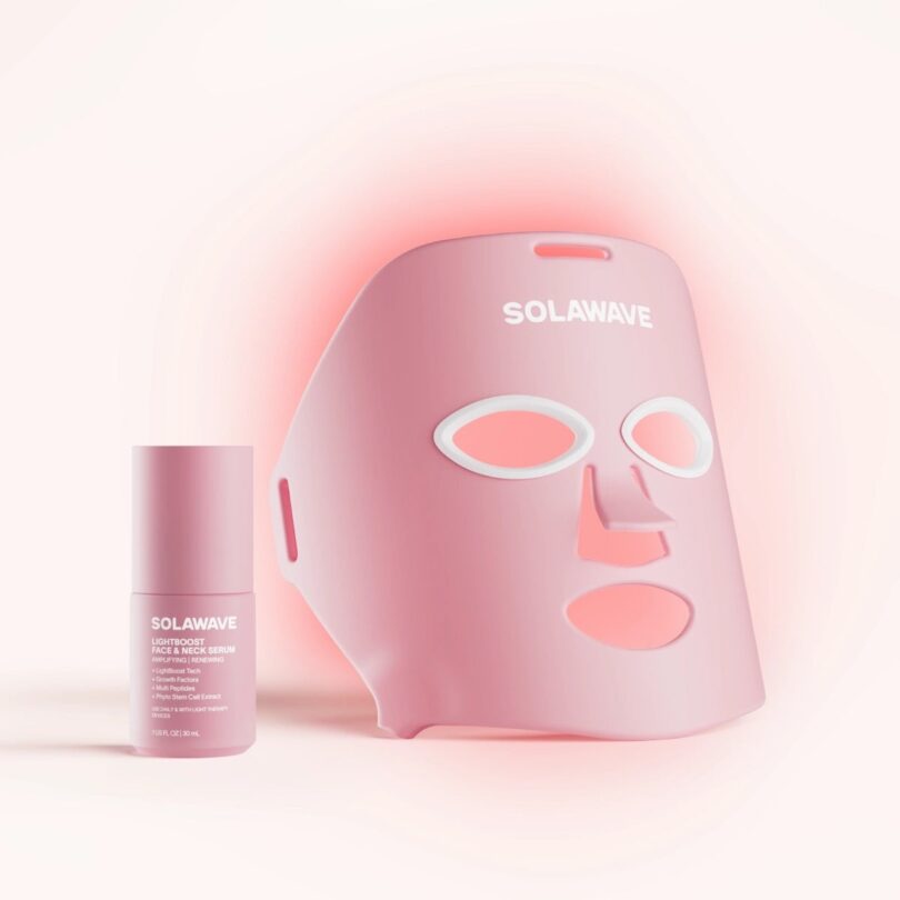 Pink Solawave LED face mask and serum bottle with soft glowing light