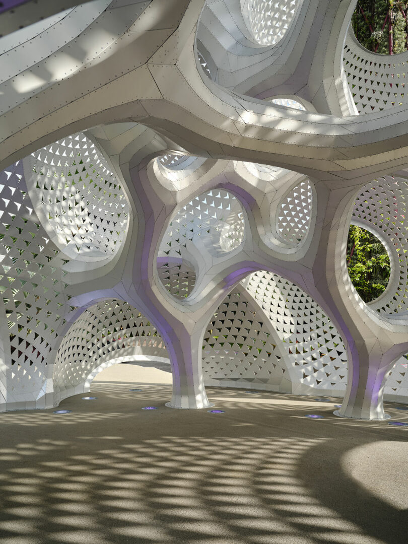 Futuristic architectural structure with intricate geometric patterns and shadows, creating a complex interplay of light and shape.