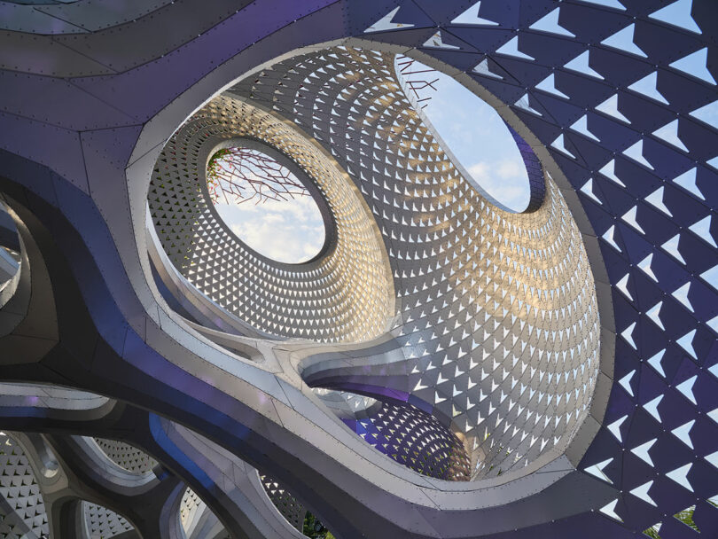 Futuristic architectural structure with perforated metal patterns and circular openings framed against the sky.