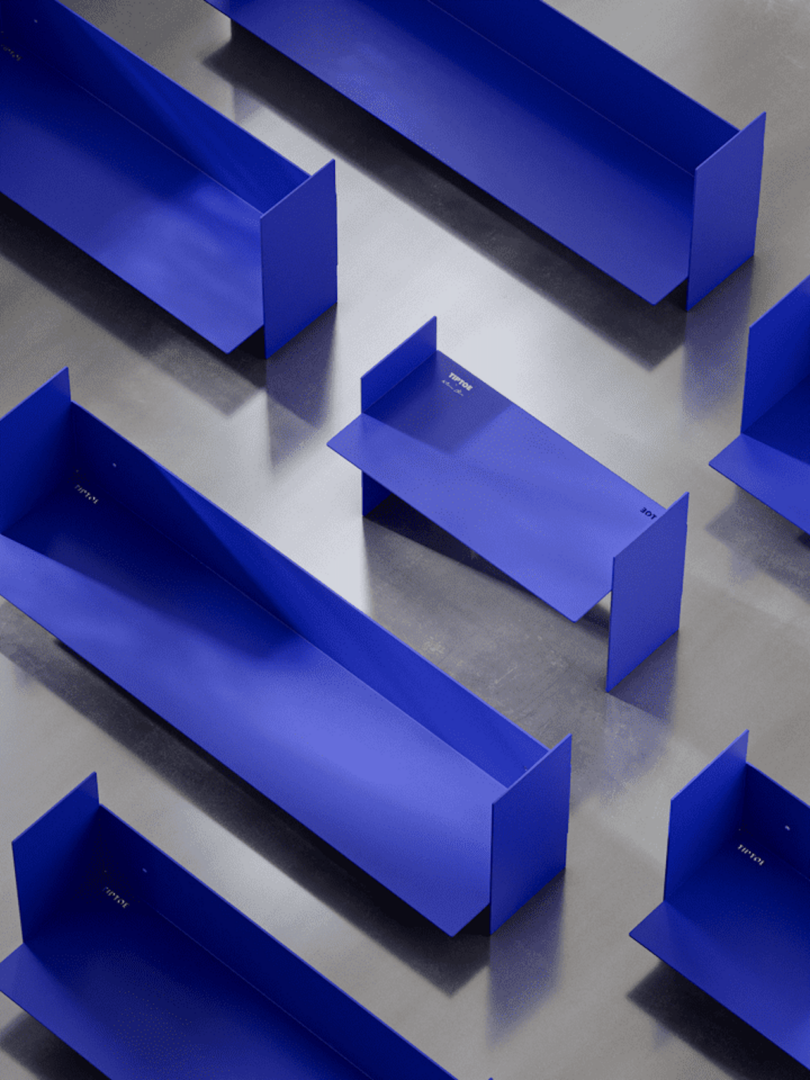 Blue rectangular metal shelves arranged on a reflective surface, viewed from above