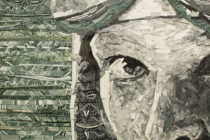 A close-up of an abstract artwork resembling a face, composed of layered paper pieces with intricate patterns in monochrome tones, predominantly green and black.