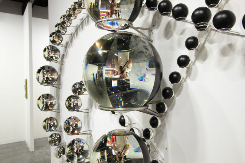 reflection of photographer in multiple glass spheres