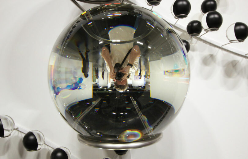 reflection of photographer in glass sphere