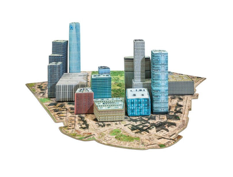 Scale model of a modern cityscape with various skyscrapers and buildings on a green and brown base.